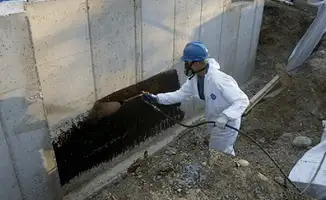 Professional waterproofing the exterior walls of the basement in Boise, ID