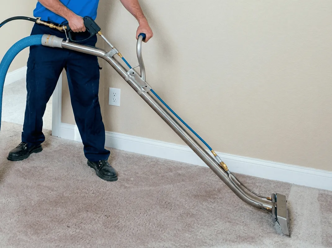 Professional operating a liquid removal machine on a carpeted floor in Boise, ID
