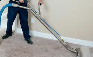 Professional operating a liquid removal machine on a carpeted floor in Boise, ID